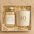 Gift set with a jar of matches and a candle in a box with shredded paper