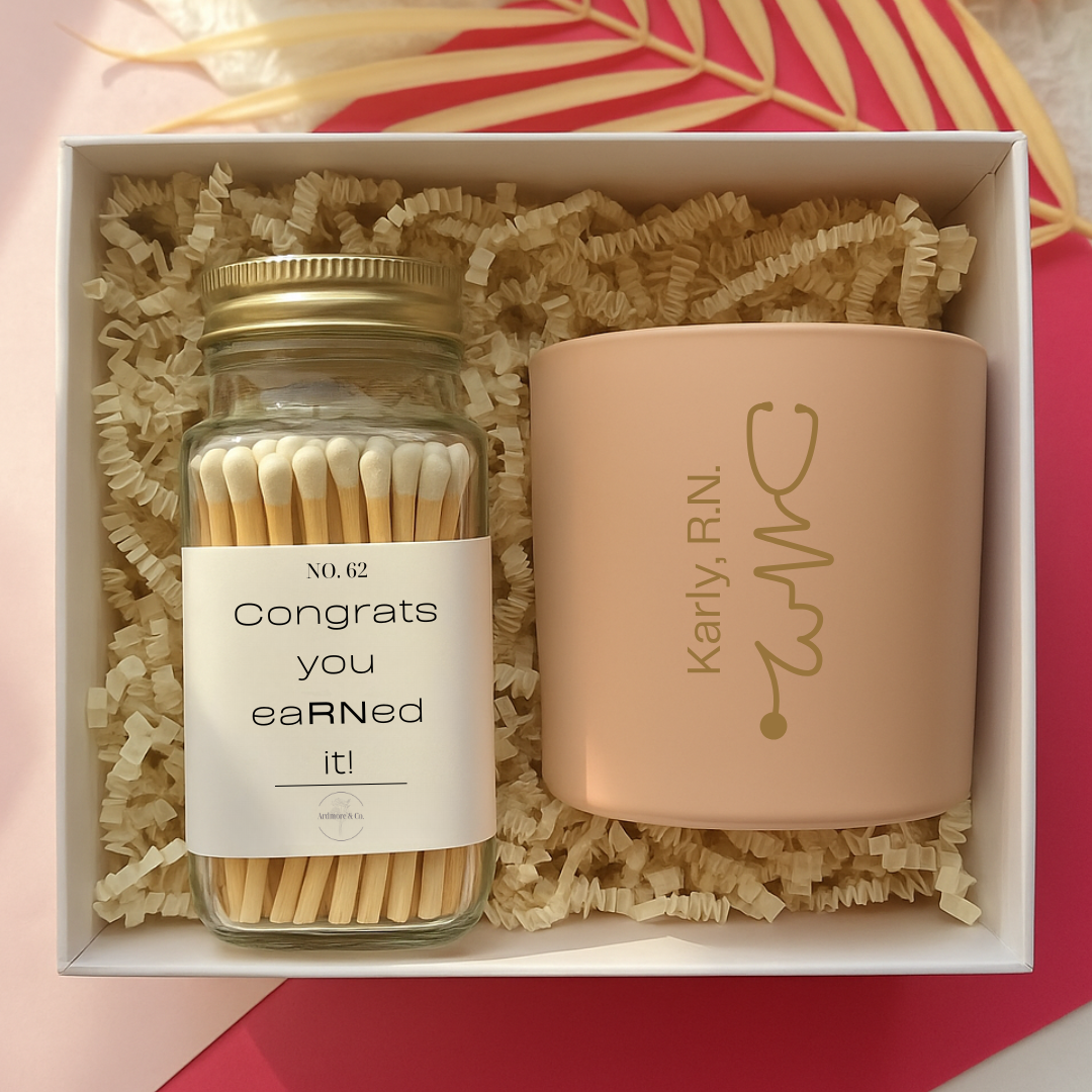 Jar of matches and pink candle with engraved name in a box on a pink and yellow background