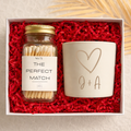 Gift set with matches and a candle in a box lined with red paper