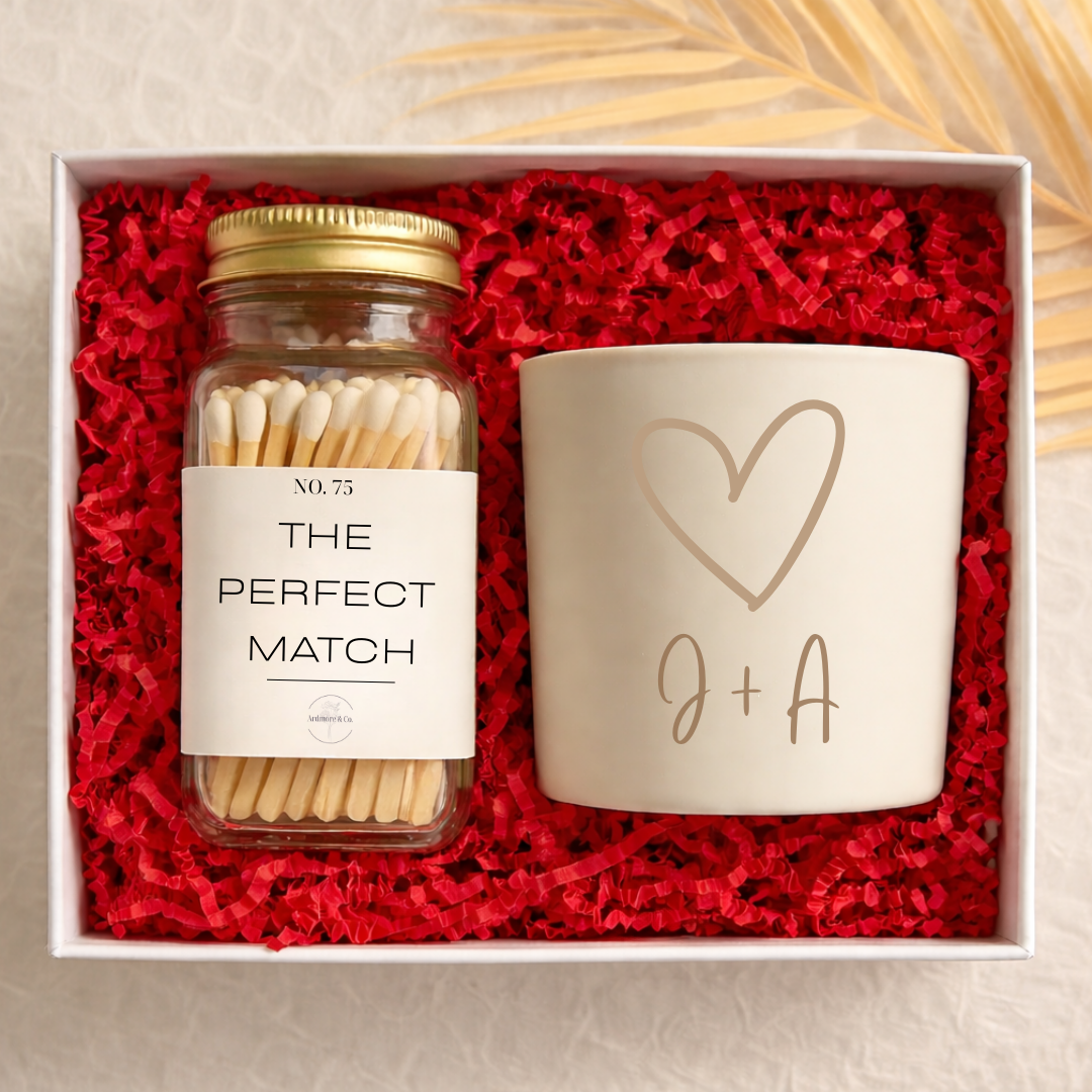Gift set with matches and a candle in a box lined with red paper