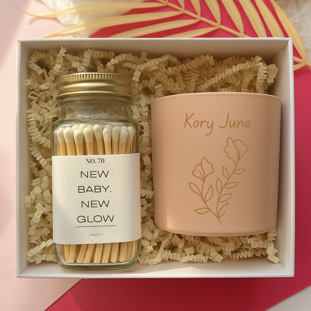 Gift set with a jar of matches and a pink candle labeled 'Kory June' in a box.