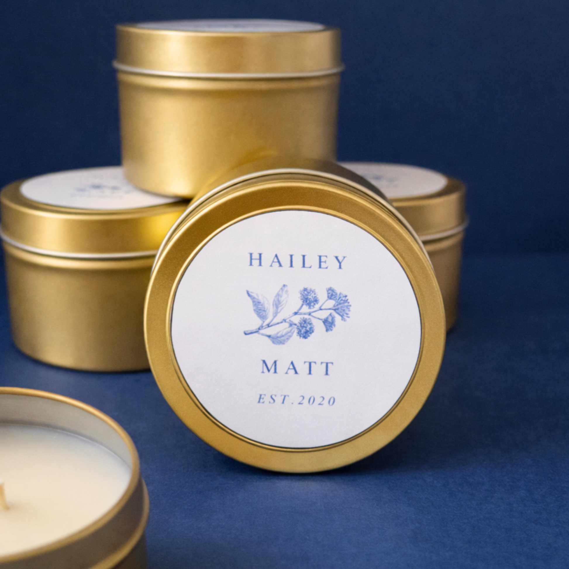 Gold tins with a decorative label on a blue background
