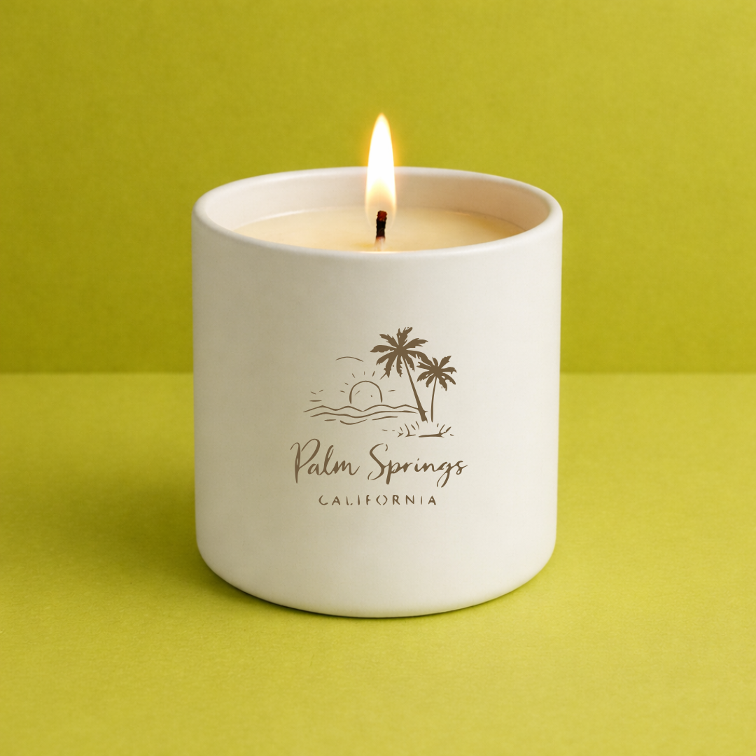 Candle in a white container with 'Palm Springs California' text and palm tree design on a green background