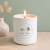 Candle in a white container with 'Lake Tahoe, California' branding on a light wooden surface.