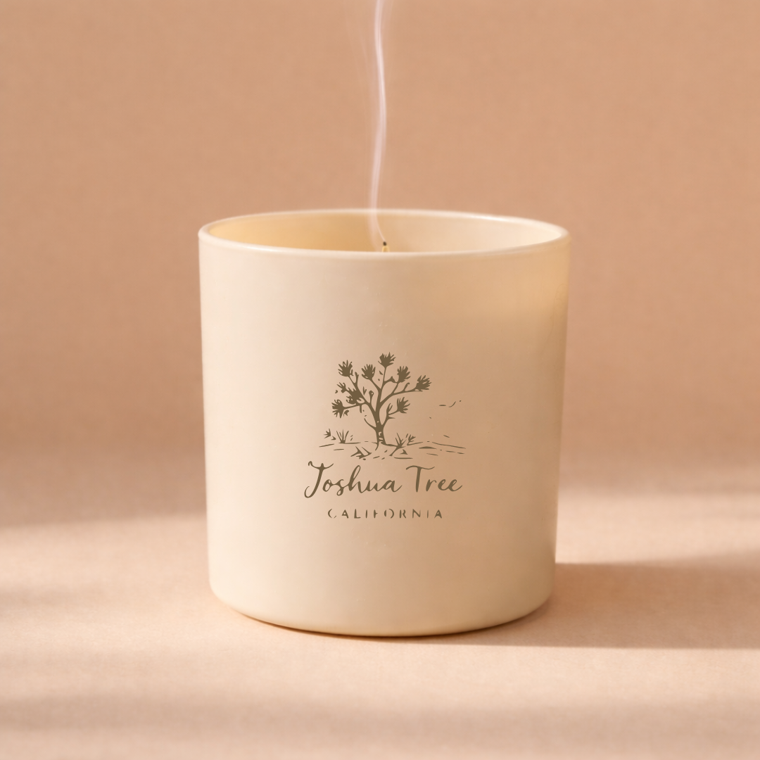 Candle in a white container with 'Joshua Tree California' branding on a beige background