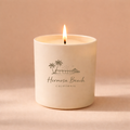 Candle in a white container with 'Hermosa Beach California' text on a beige background