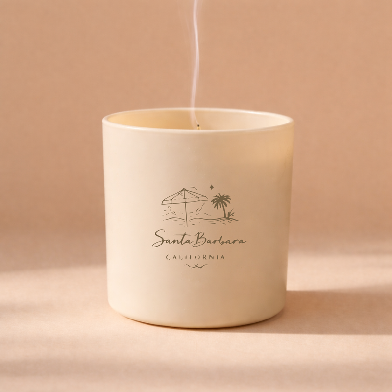 Candle in a white container with 'Santa Barbara California' text on a beige background